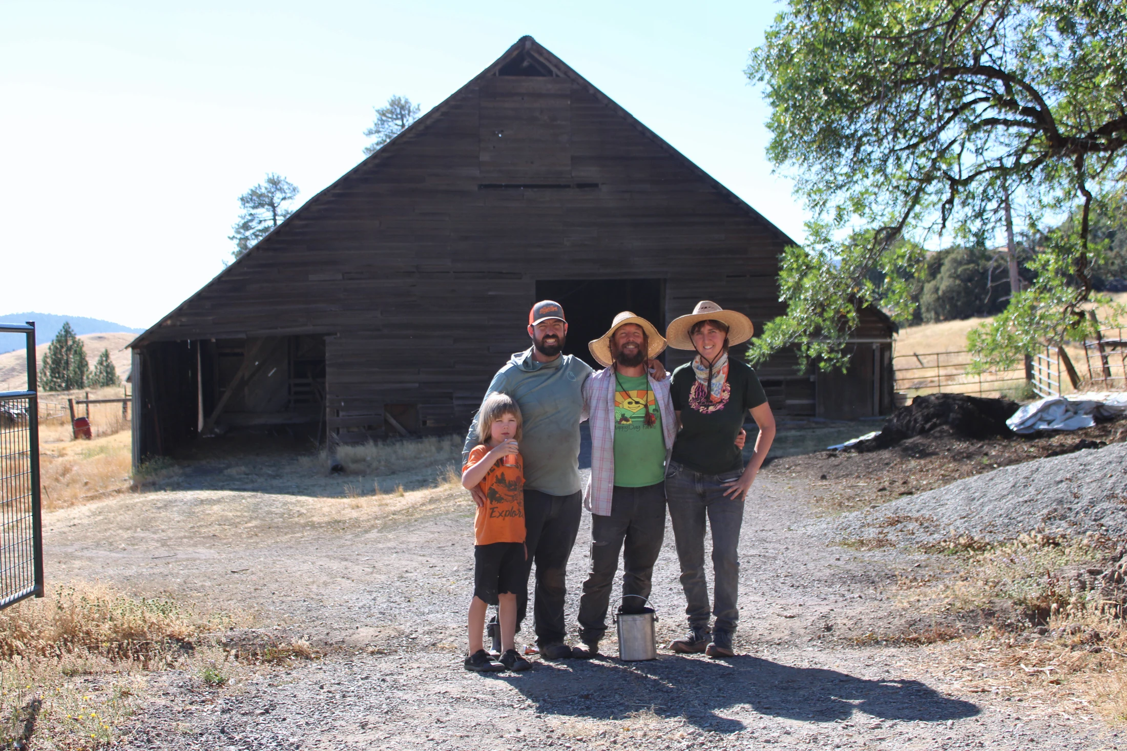 HappyDay Farms family and farm crew in front of a barn